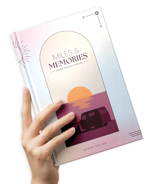 A hand holding the Miles & Memories journal – Sunset Edition